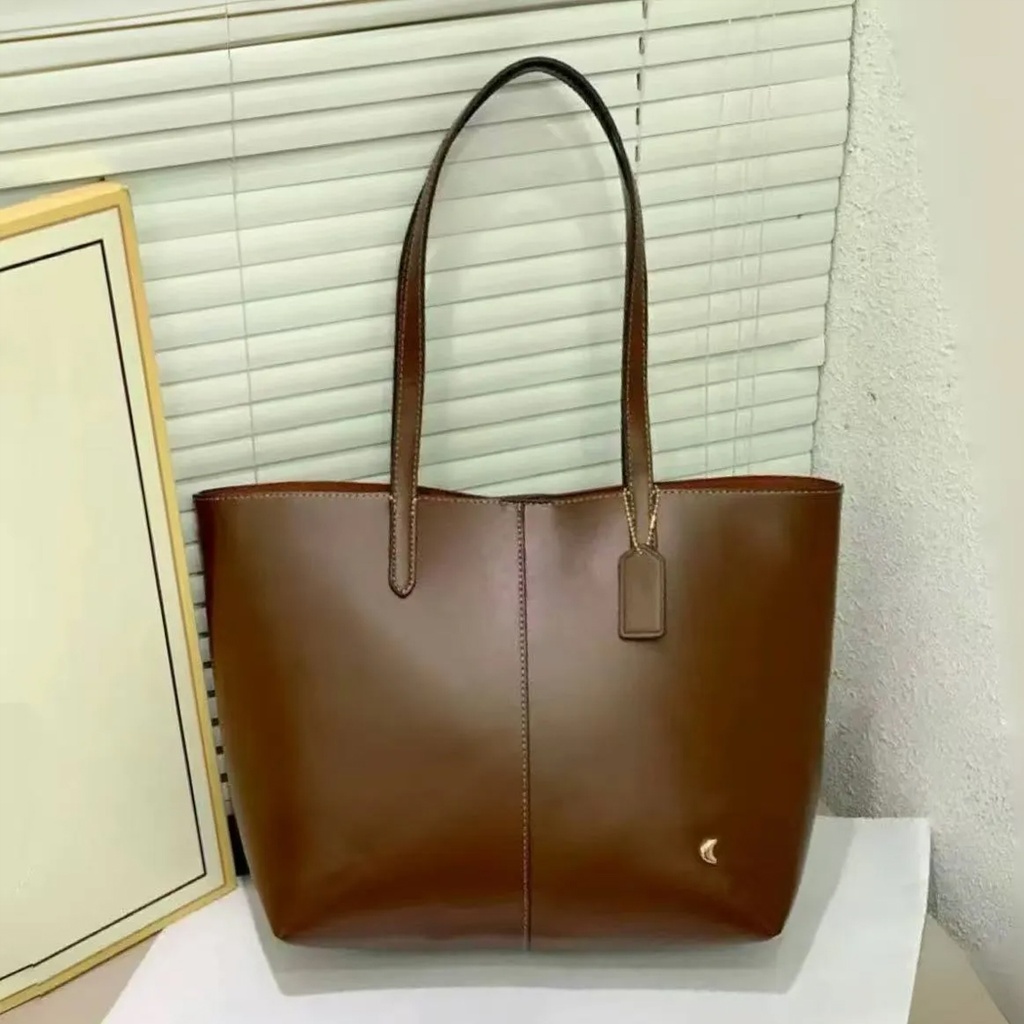 Cartera Coach de cuero para mujer.